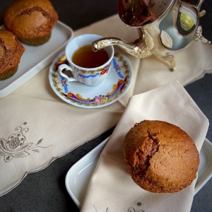 muffin al cioccolato al latte e banana in primo piano con altri muffins sullo sfondo